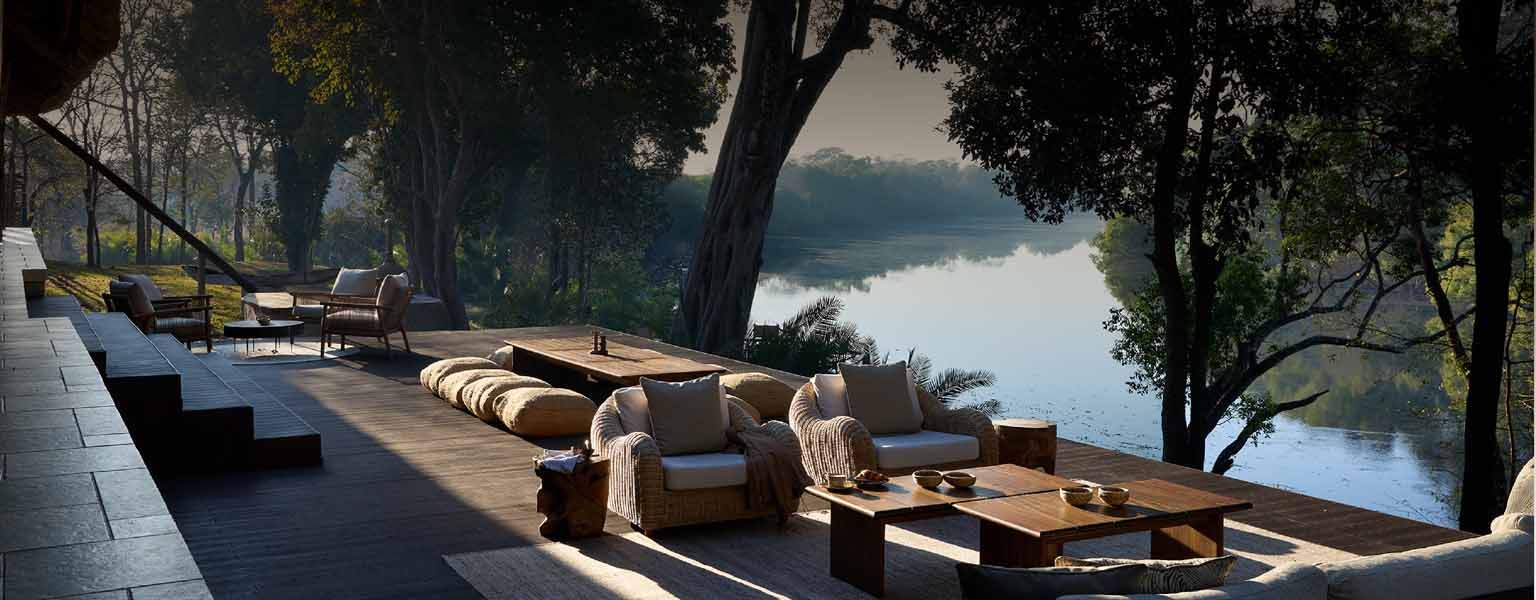 Deck lounge seating above a Zambian river