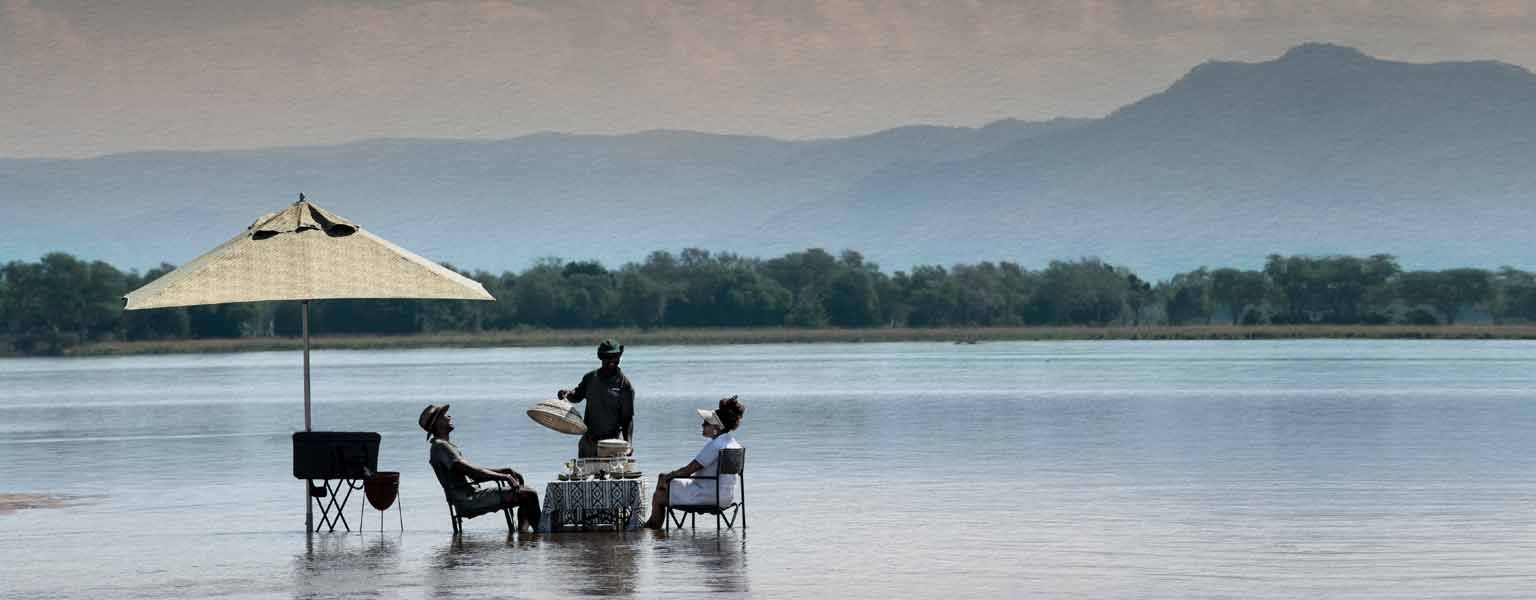 A table set in the shallows of the Zambezi River