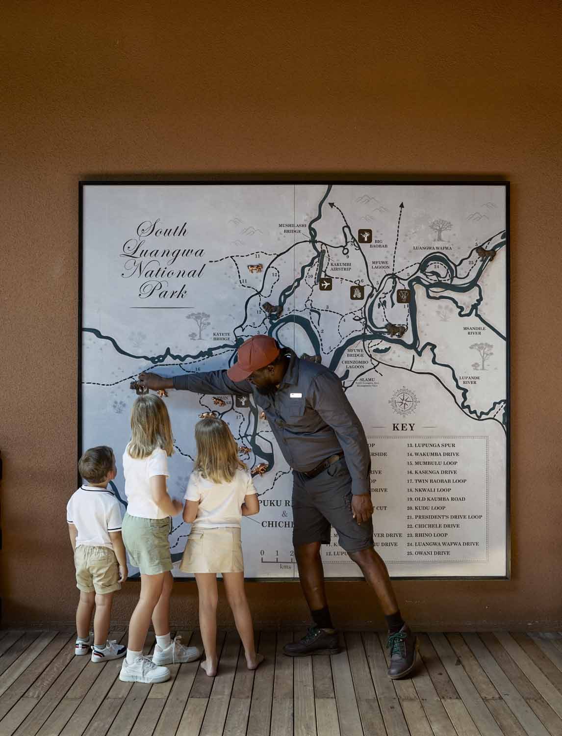 A Chichele Cubs guide shows three children the big map of South Luangwa National Park