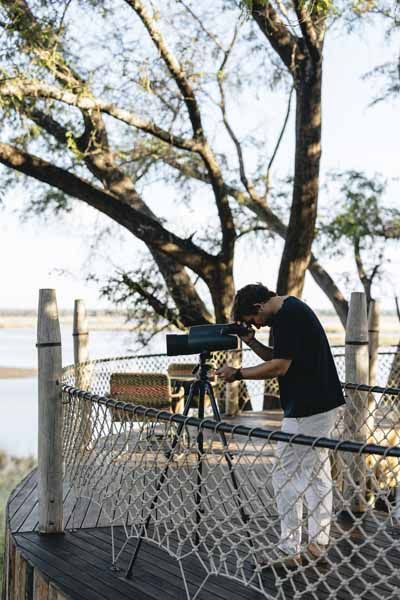 A guest photographing the Zambezi from the Lolebezi deck
