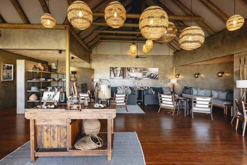 The main lounge at Lolebezi beneath hand-woven pendant lights