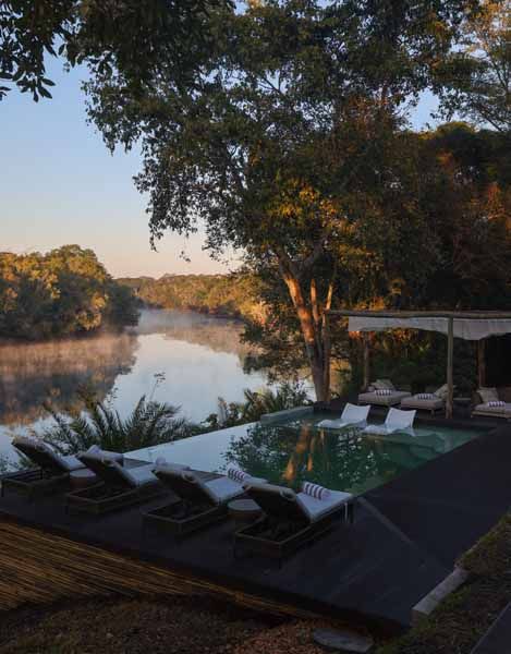 Pool terrace shaded by winterthorn trees at Lolebezi